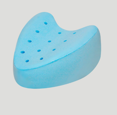 Blue pillow with holes on a light gray background